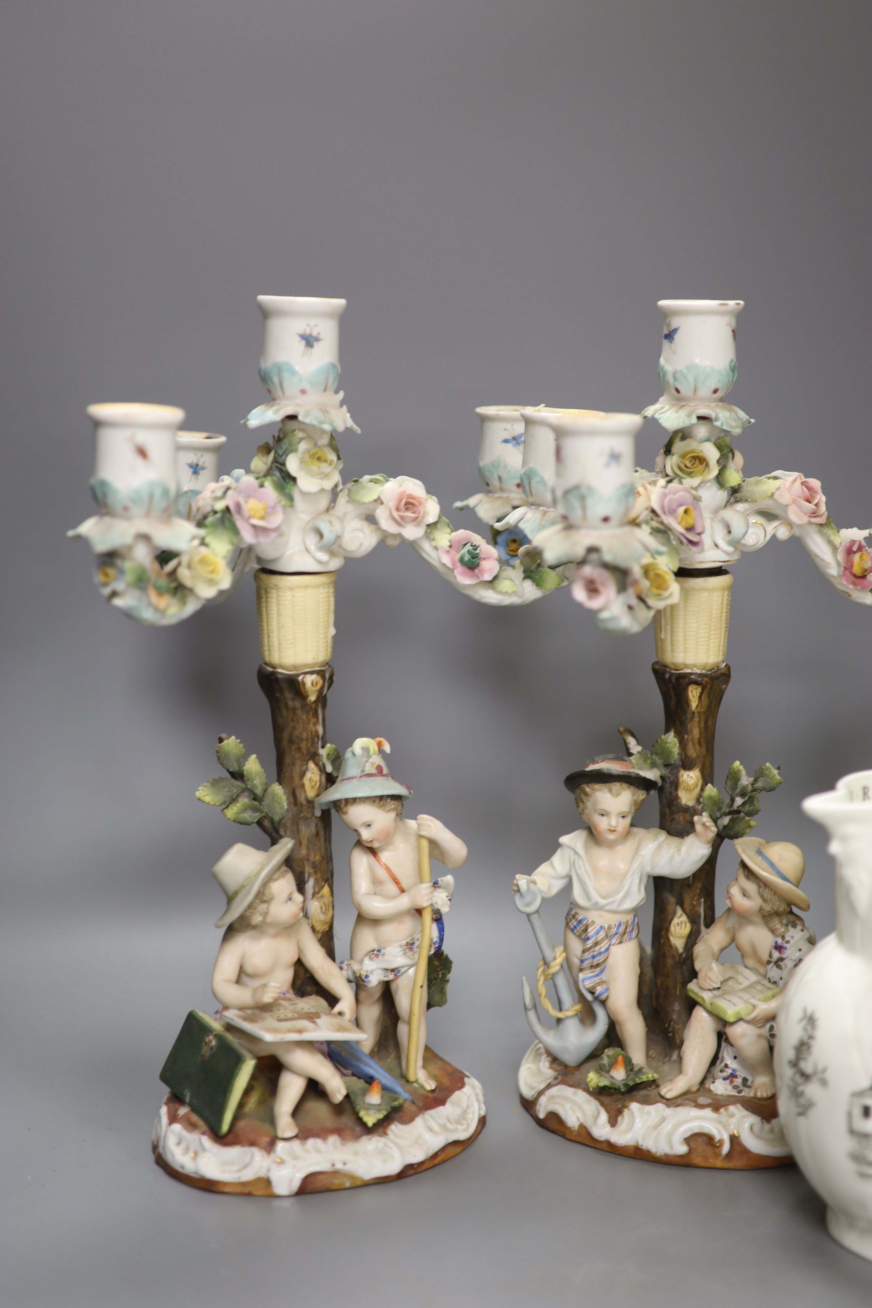 A pair of Continental porcelain floral figural three light candelabra, height 34cm, a Crown Devon Fieldings jug and a Worcester jug